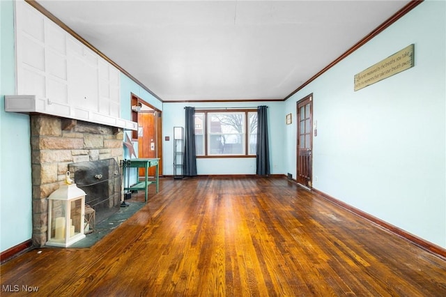 unfurnished living room with a fireplace, ornamental molding, and dark wood-type flooring