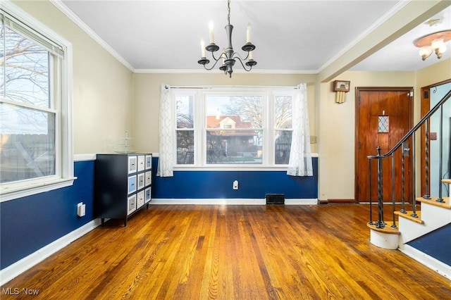 unfurnished dining area featuring hardwood / wood-style floors, a chandelier, and plenty of natural light