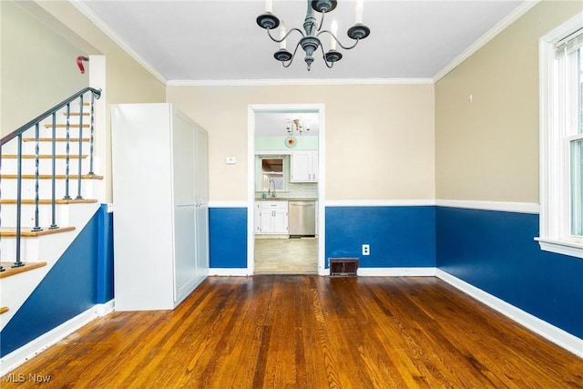 spare room featuring dark hardwood / wood-style floors, ornamental molding, and sink