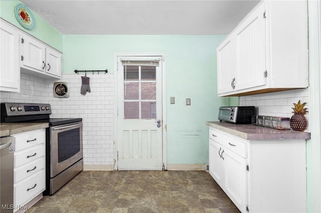 kitchen with white cabinets, appliances with stainless steel finishes, and tasteful backsplash