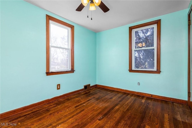 empty room featuring ceiling fan and dark wood-type flooring