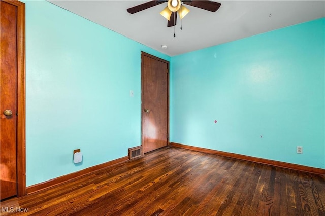 unfurnished bedroom featuring ceiling fan and dark hardwood / wood-style flooring