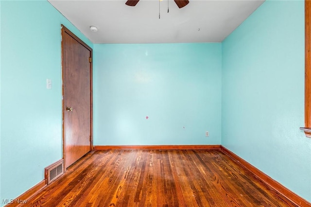 spare room featuring ceiling fan and dark hardwood / wood-style flooring