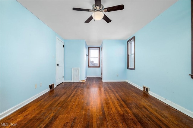 empty room with ceiling fan and dark wood-type flooring