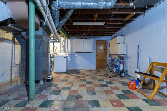 basement featuring washer / dryer and heating unit