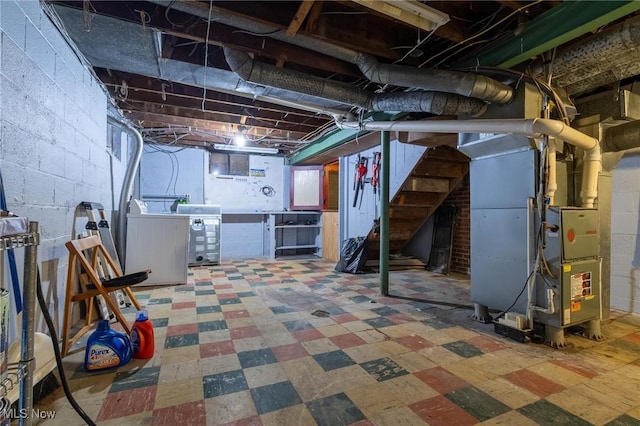 basement with washing machine and clothes dryer and heating unit