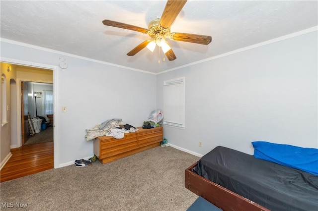 carpeted bedroom with ceiling fan and crown molding