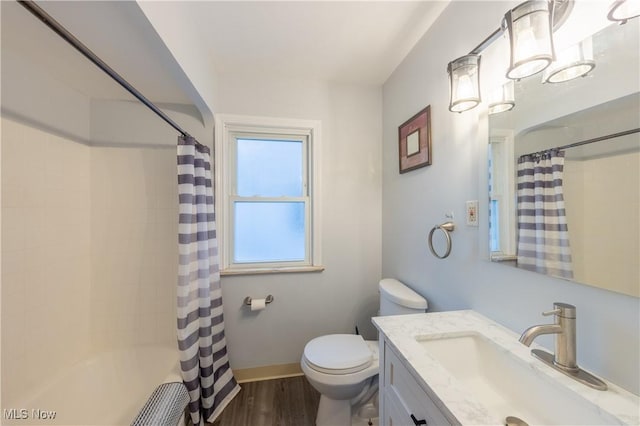 full bathroom with vanity, hardwood / wood-style flooring, toilet, and shower / bath combo with shower curtain