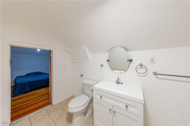 bathroom with tile patterned flooring, vanity, and toilet