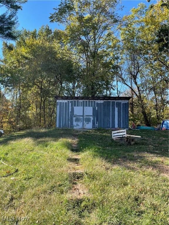 view of outbuilding with a yard