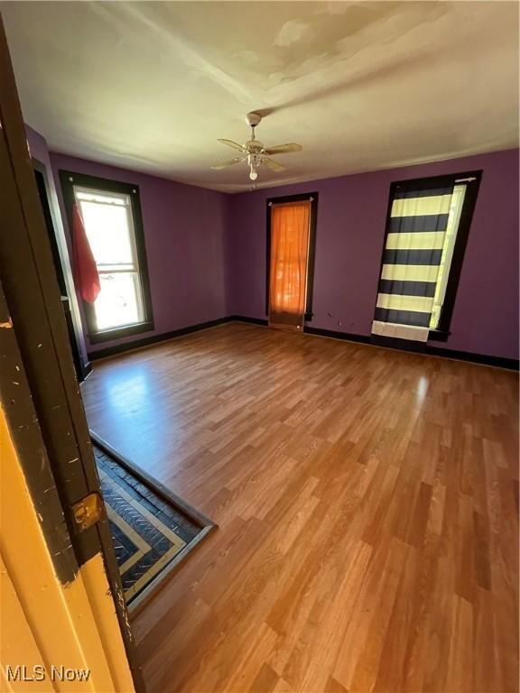 unfurnished room featuring hardwood / wood-style flooring and ceiling fan