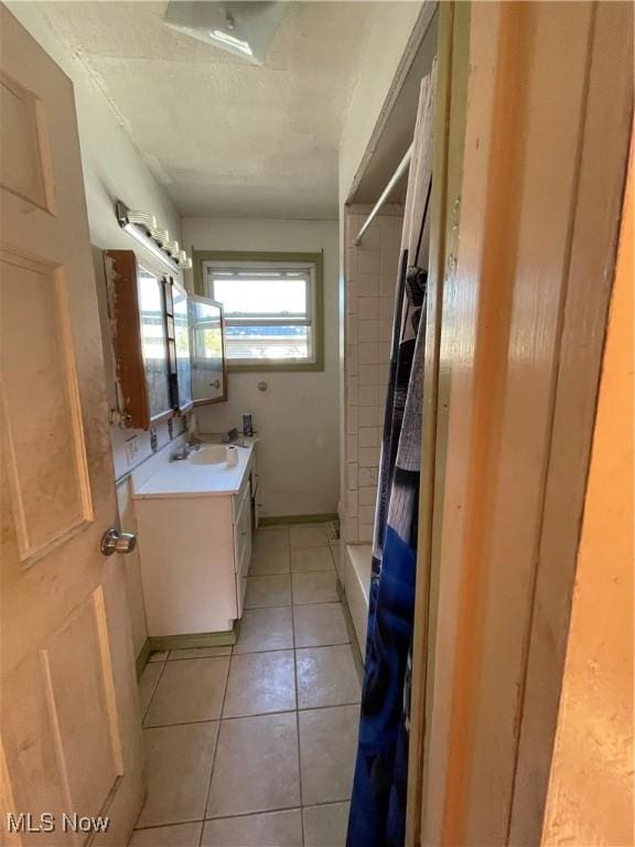 bathroom featuring tile patterned floors, vanity, and a shower with shower curtain