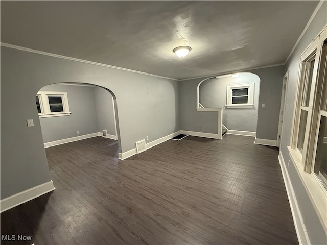 interior space with dark hardwood / wood-style floors and ornamental molding