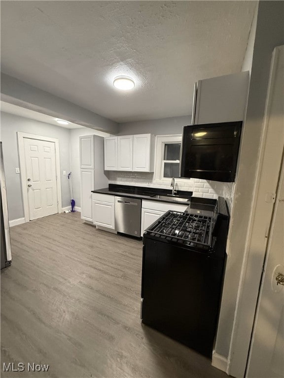 kitchen with white cabinetry, light wood-type flooring, dishwasher, black gas stove, and sink