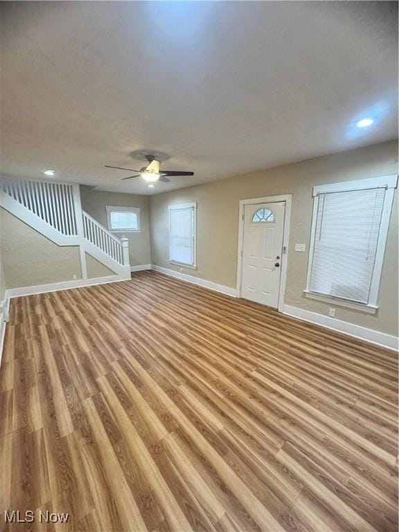 unfurnished living room featuring light hardwood / wood-style floors and ceiling fan