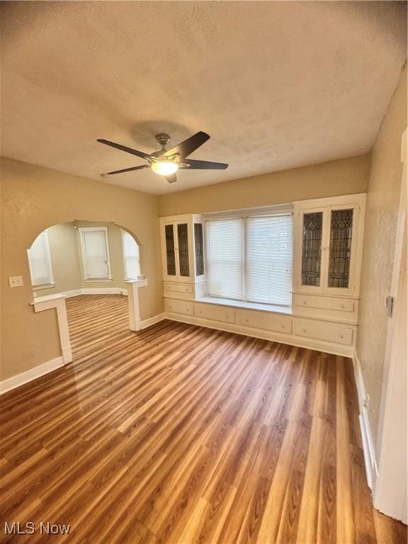 interior space featuring hardwood / wood-style floors, a textured ceiling, and ceiling fan