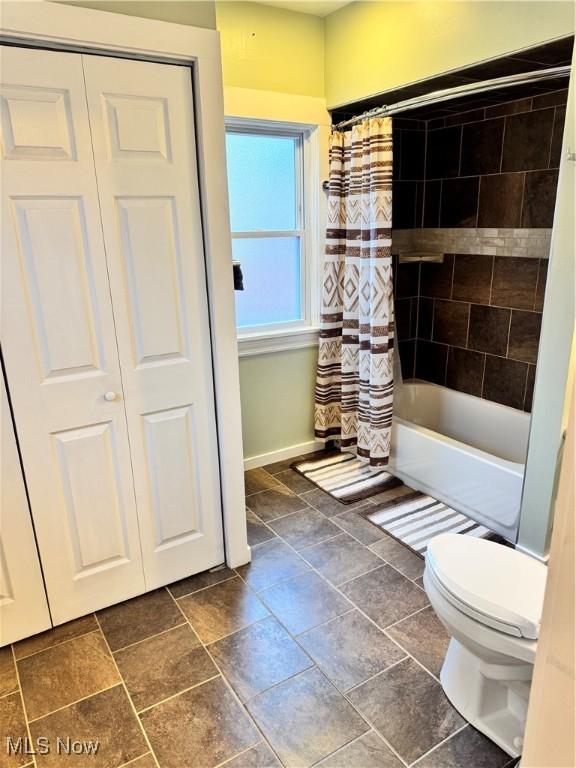 bathroom with toilet and shower / tub combo