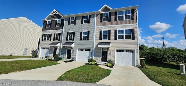 multi unit property with a front yard and a garage