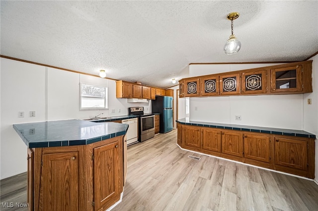 kitchen with pendant lighting, lofted ceiling, stainless steel range with electric stovetop, white dishwasher, and black fridge