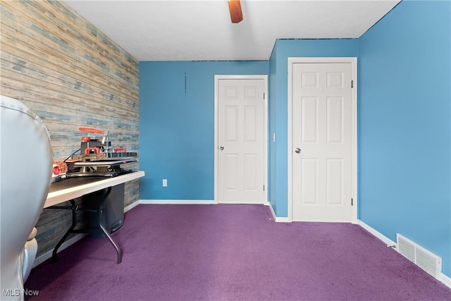 carpeted office featuring ceiling fan