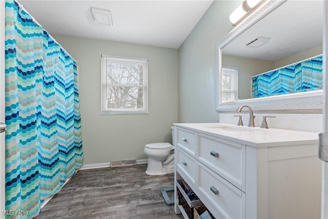 bathroom with vanity, wood-type flooring, and toilet