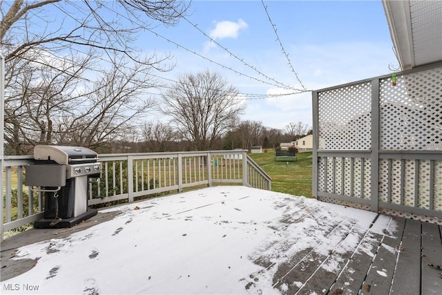 wooden deck with area for grilling and a lawn