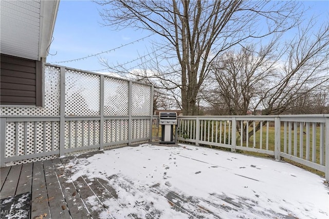 snow covered deck featuring a grill