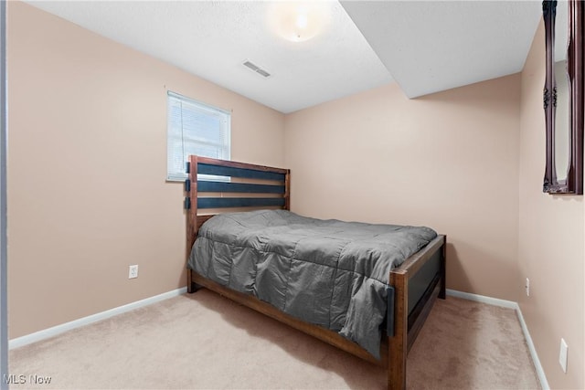 bedroom featuring light carpet