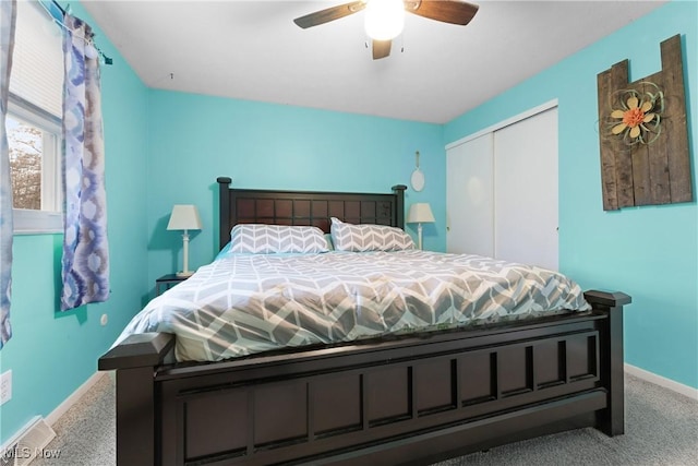 carpeted bedroom with a closet and ceiling fan