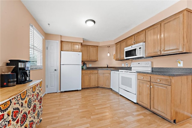 kitchen featuring sink, light hardwood / wood-style floors, and white appliances