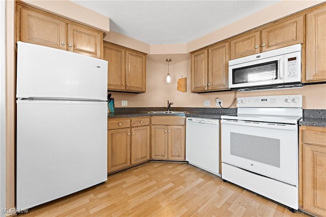 kitchen featuring decorative light fixtures, light wood-type flooring, white appliances, and sink