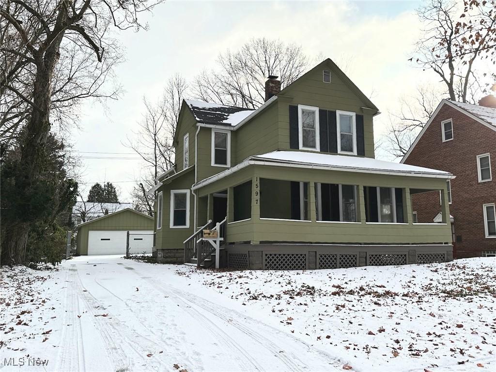 view of front of property featuring an outdoor structure and a garage