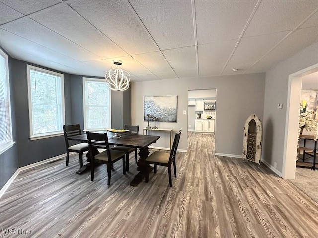 dining room featuring wood-type flooring and a chandelier