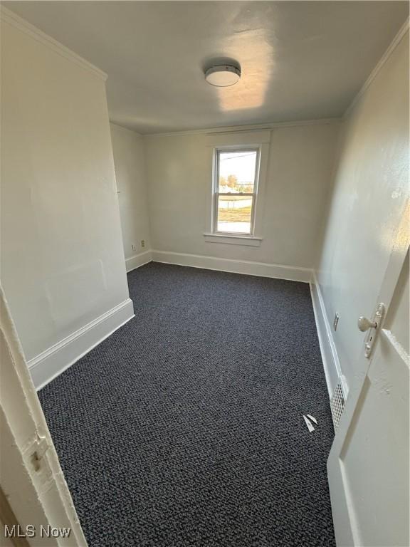 carpeted spare room with ornamental molding