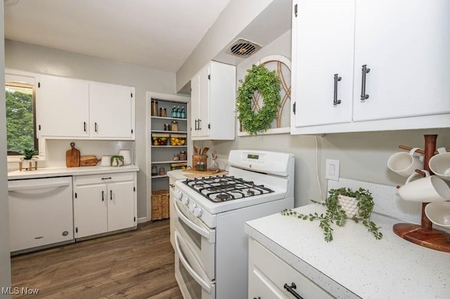 kitchen with white cabinetry, dark hardwood / wood-style flooring, and white appliances