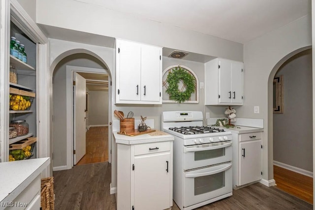 kitchen featuring dark hardwood / wood-style floors, white cabinetry, and white range with gas cooktop