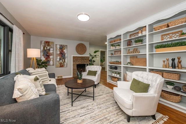 living area featuring a fireplace and hardwood / wood-style flooring