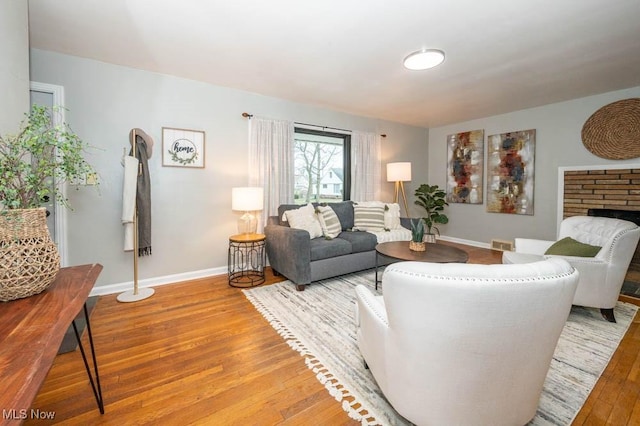 living room with a fireplace and light hardwood / wood-style flooring