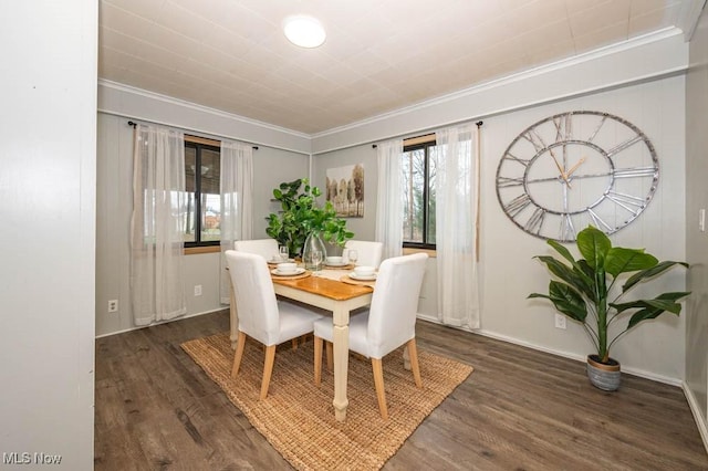 dining area with dark wood-type flooring and ornamental molding