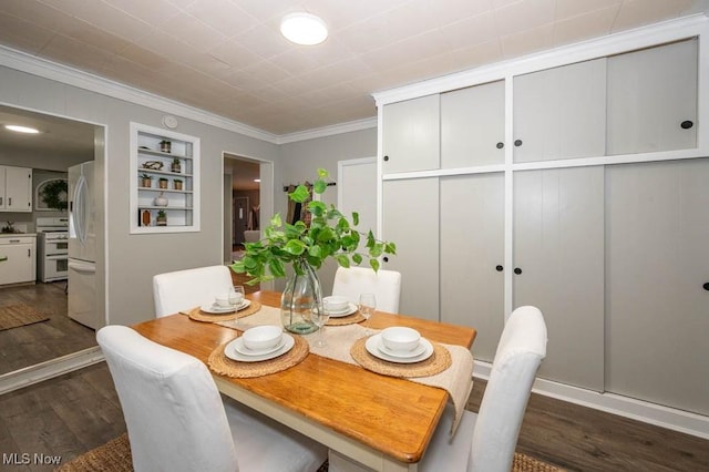 dining area featuring dark hardwood / wood-style flooring, built in features, and ornamental molding