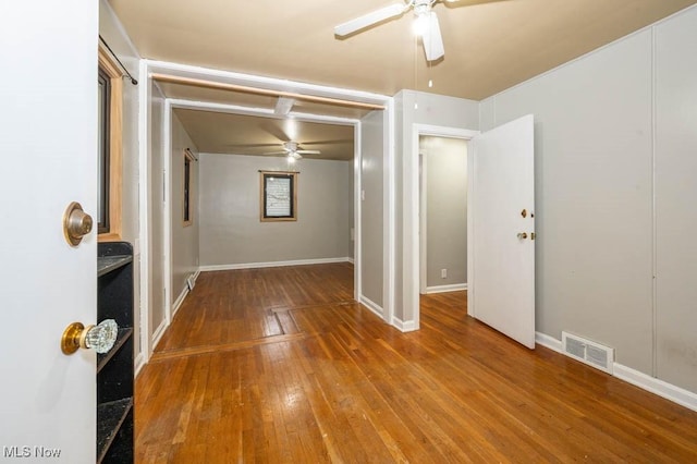 spare room featuring hardwood / wood-style floors and ceiling fan