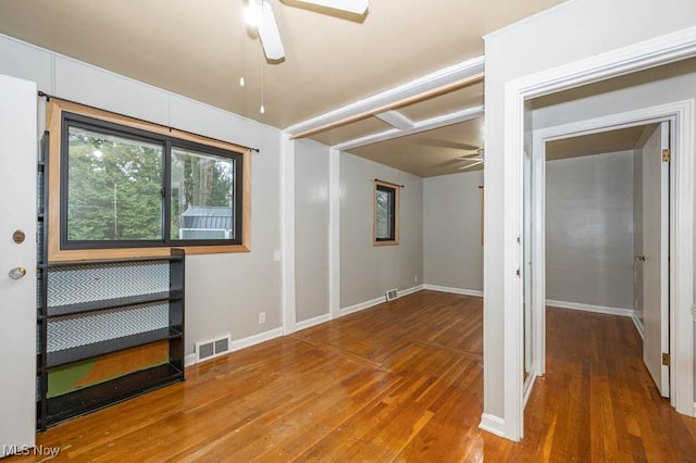 spare room featuring ceiling fan and dark wood-type flooring