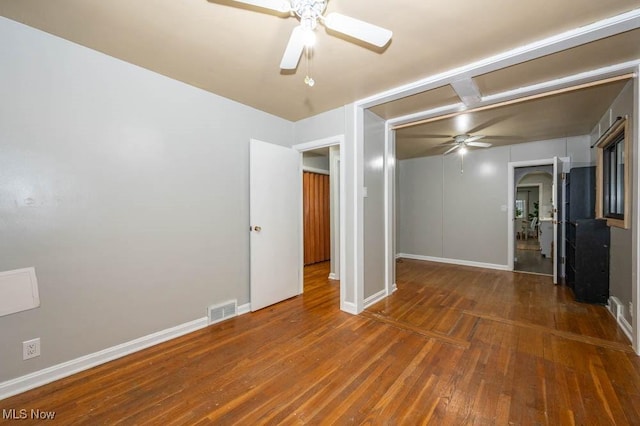 spare room with ceiling fan and dark wood-type flooring