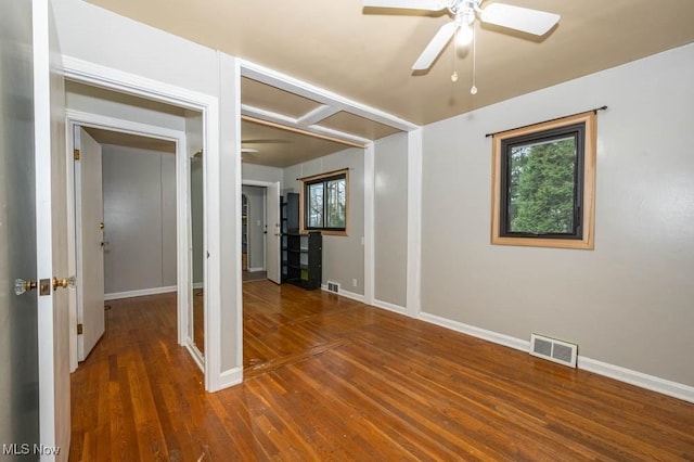 spare room featuring ceiling fan and dark hardwood / wood-style flooring