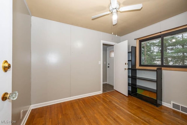 unfurnished bedroom featuring ceiling fan and hardwood / wood-style flooring