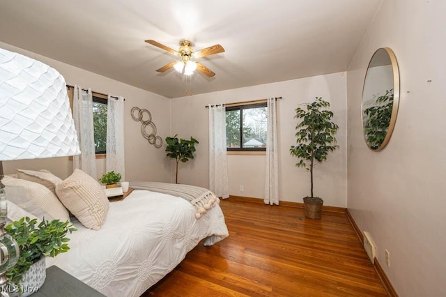 bedroom with hardwood / wood-style floors and ceiling fan