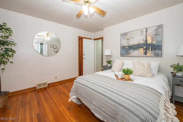 bedroom with ceiling fan and hardwood / wood-style flooring