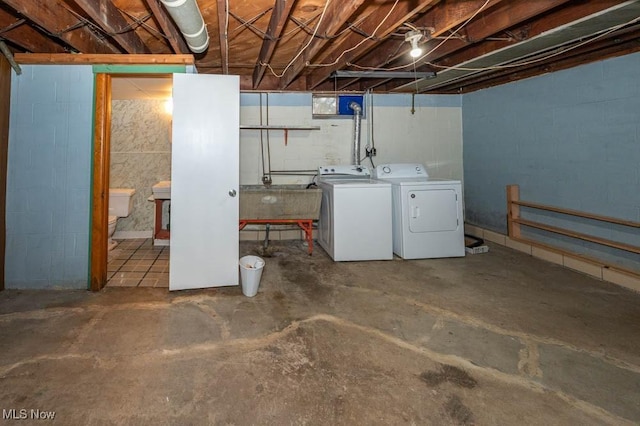 basement with washing machine and dryer and sink