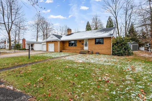 ranch-style house with a front lawn and a shed