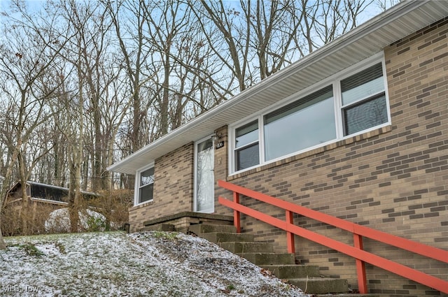 view of snow covered property entrance